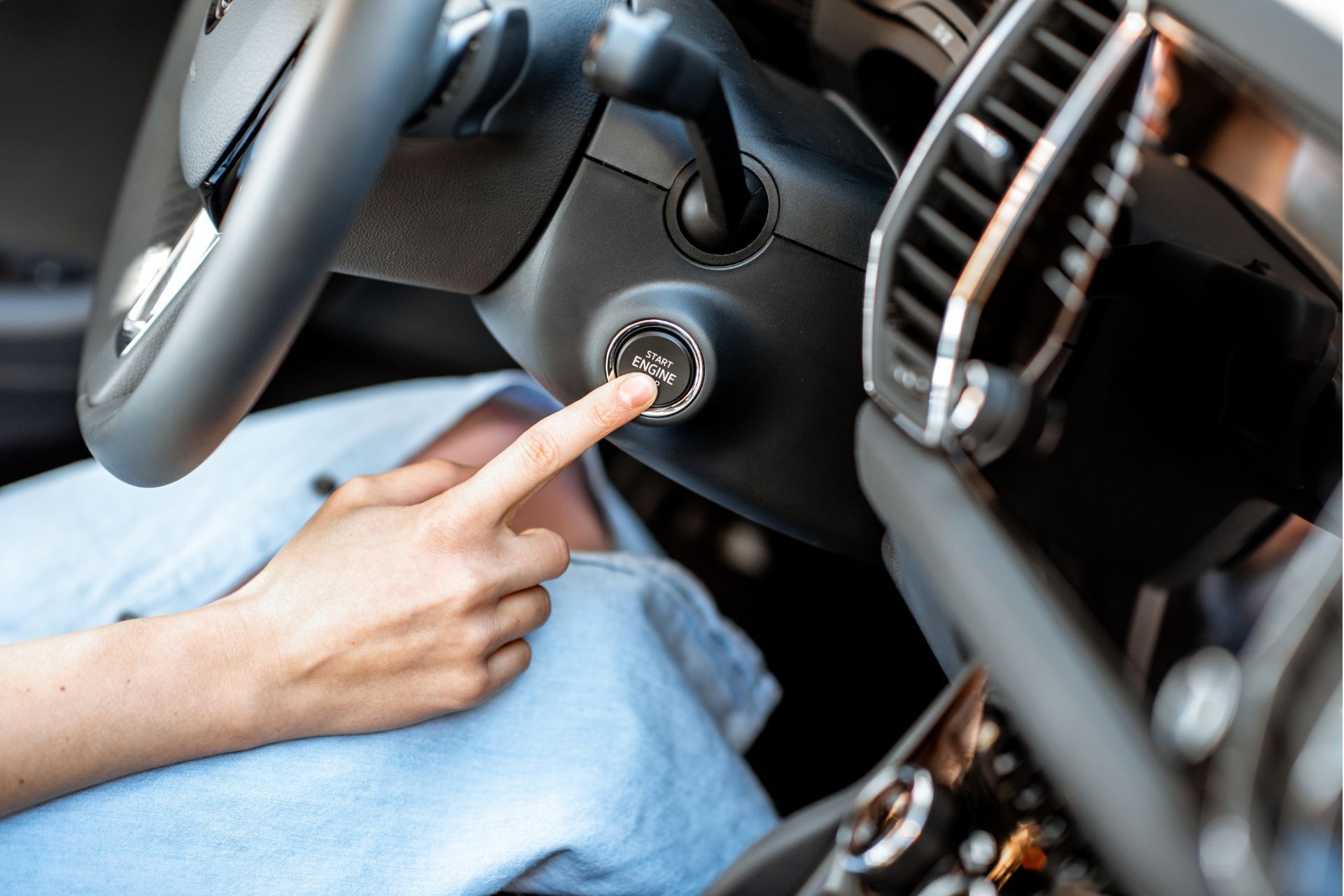 A person is starting a car with their finger.