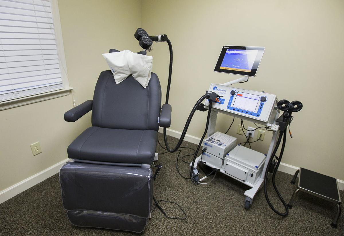 A chair with a pillow on top of it is in a room with medical equipment.