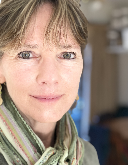 A close up of a woman wearing a scarf and earrings.