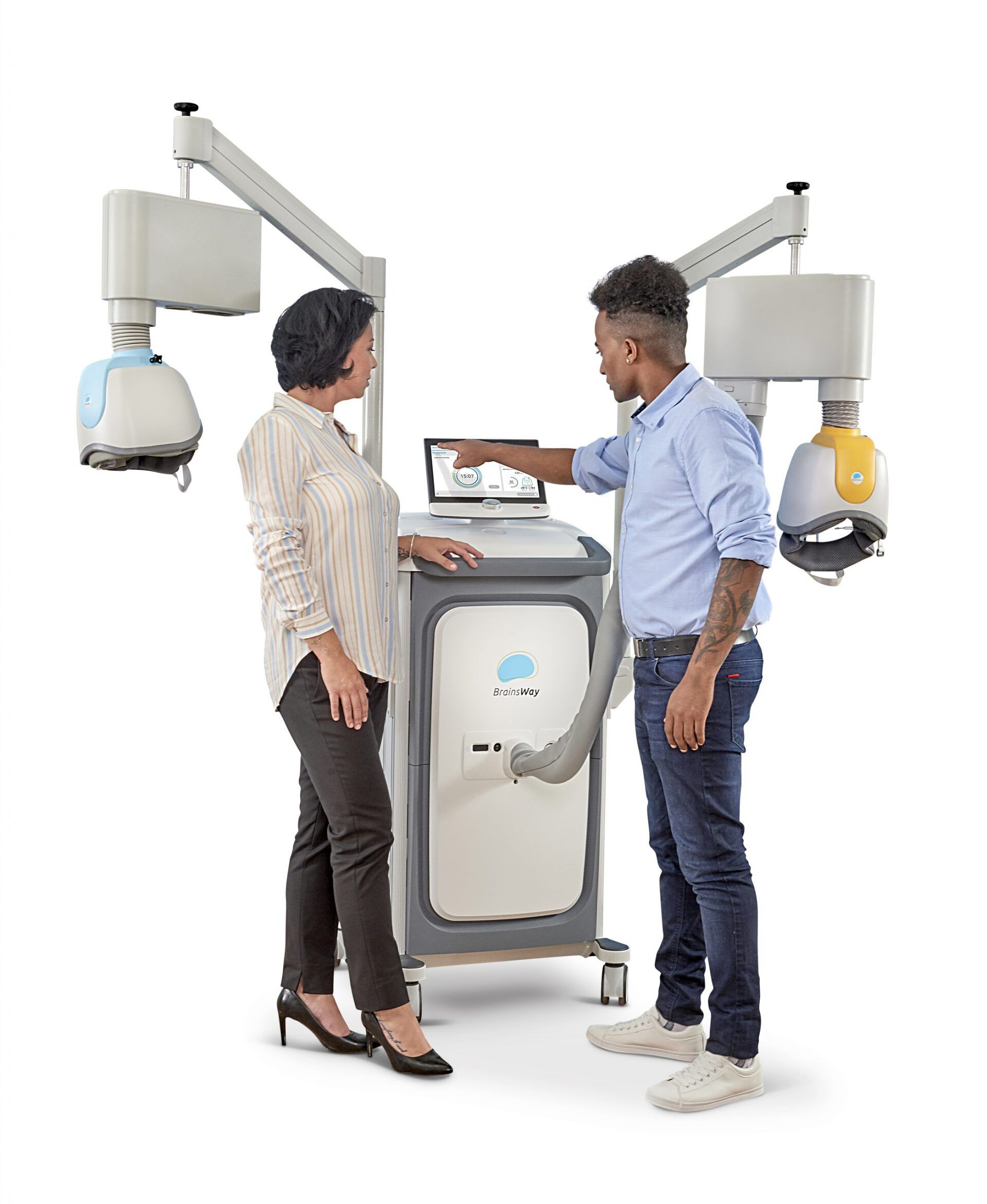 A man and a woman are standing next to a machine.