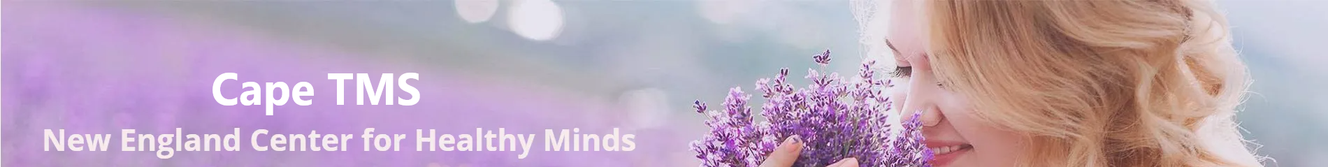 A woman is holding a bouquet of purple flowers.