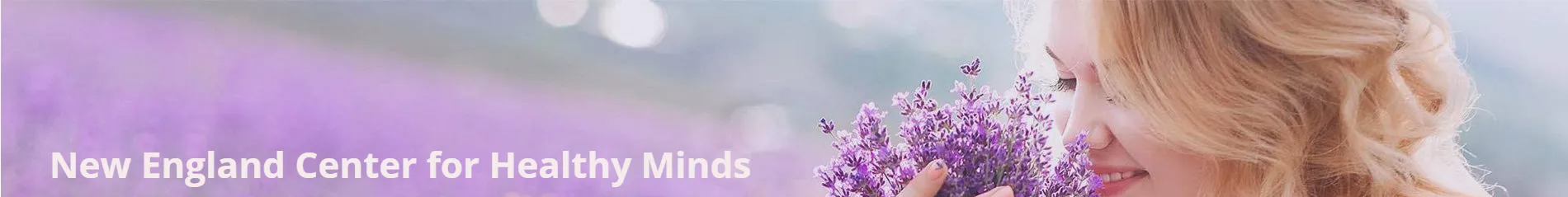 A woman is holding a bouquet of purple flowers in her hand.