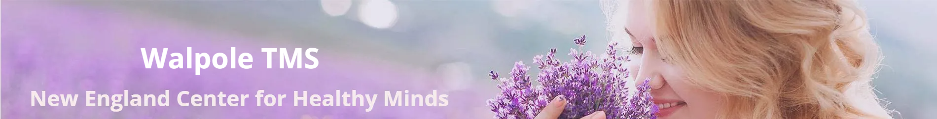 A woman is holding a bouquet of purple flowers.