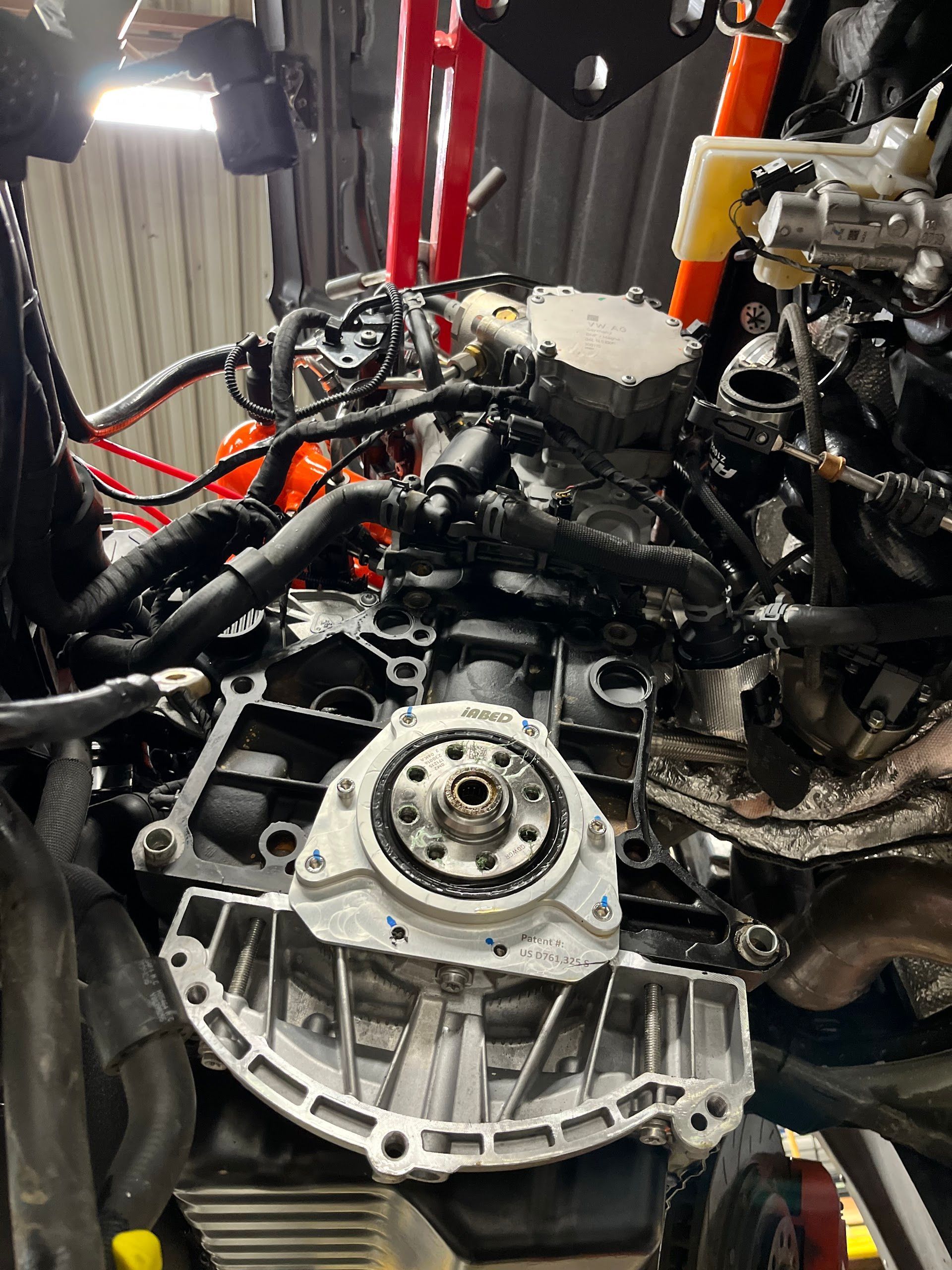 Engine block, partially disassembled, viewed from the front, in a garage. Various wires and components are visible.  | A2B Euro Car Repair