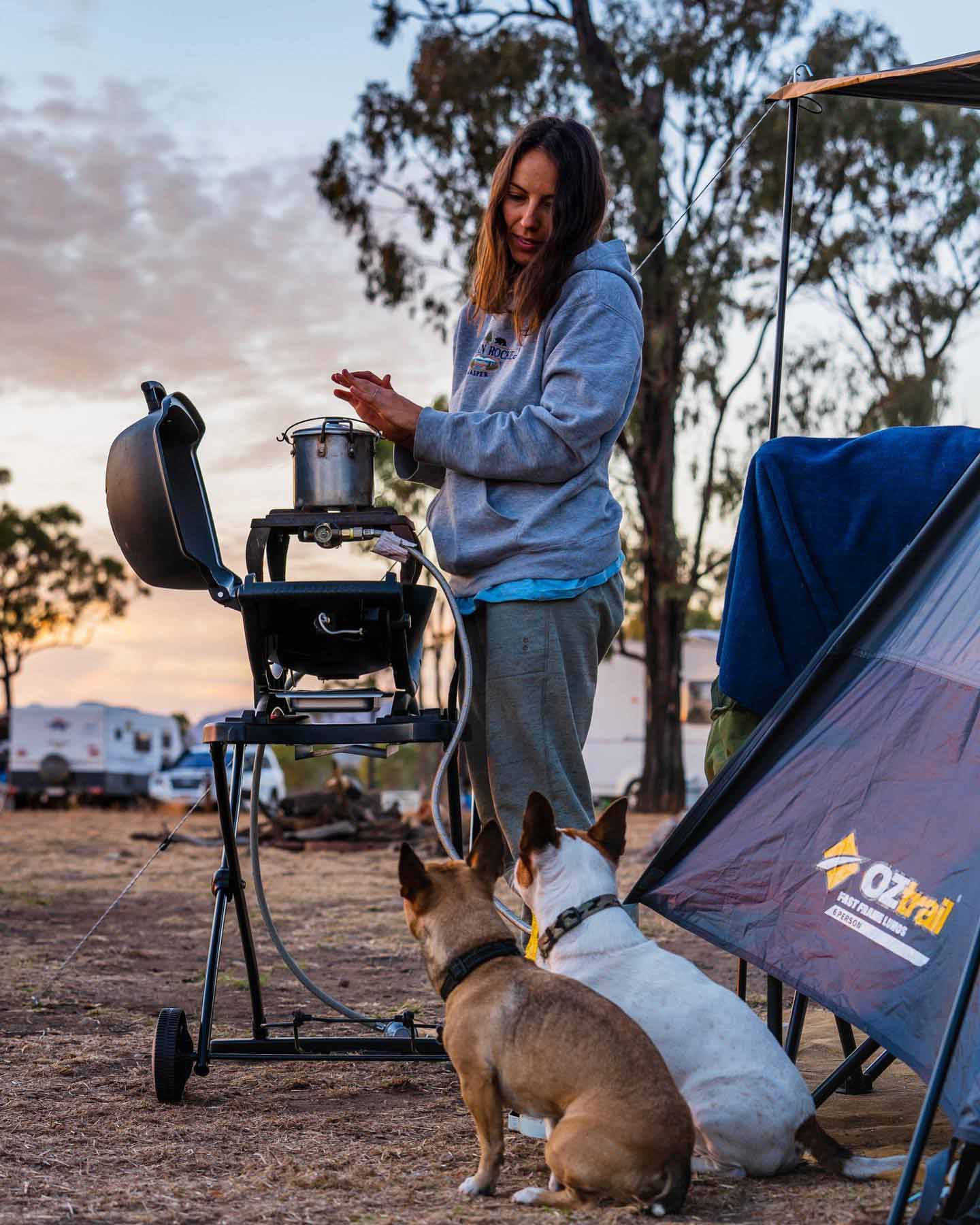 A Woman with Two Dogs — Camping Store in Mackay, QLD