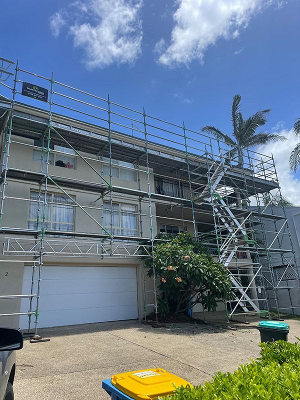 A Building With Scaffolding on the Side of It is Being Painted — RM Scaffolding Solutions in Kingscliff, NSW