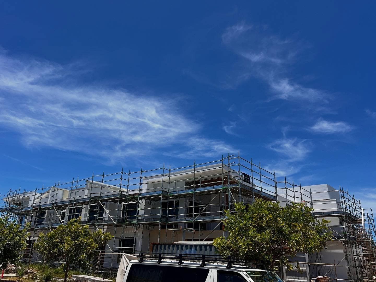 A Large Building Under Construction With a Blue Sky in the Background — RM Scaffolding Solutions in Tweed Heads, NSW