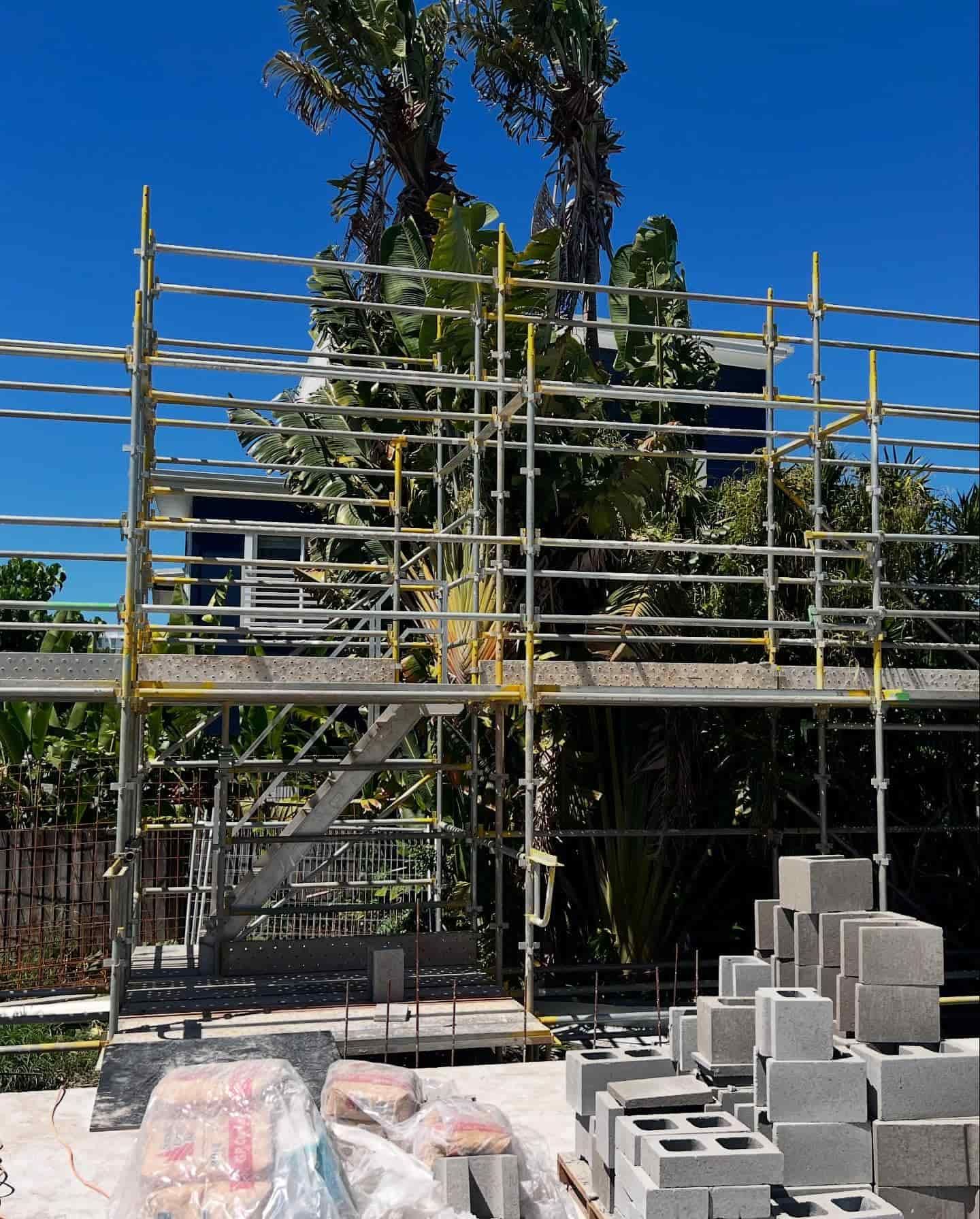 A Construction Site With a Lot of Bricks and Scaffolding — RM Scaffolding Solutions in Pottsville, NSW