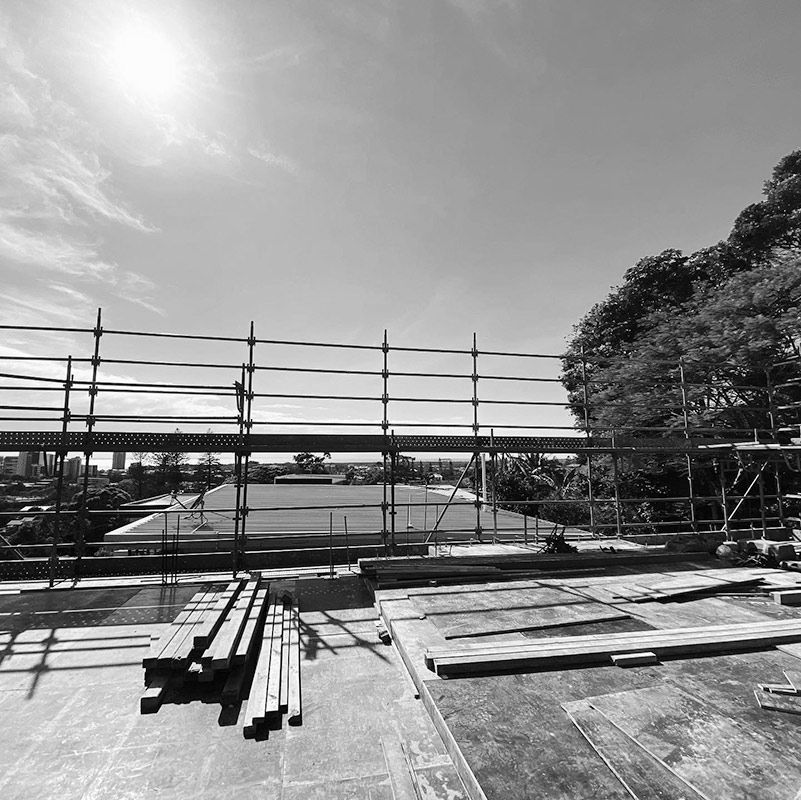 A Black and White Photo of a Construction Site With Scaffolding — RM Scaffolding Solutions in Tweed Coast, NSW