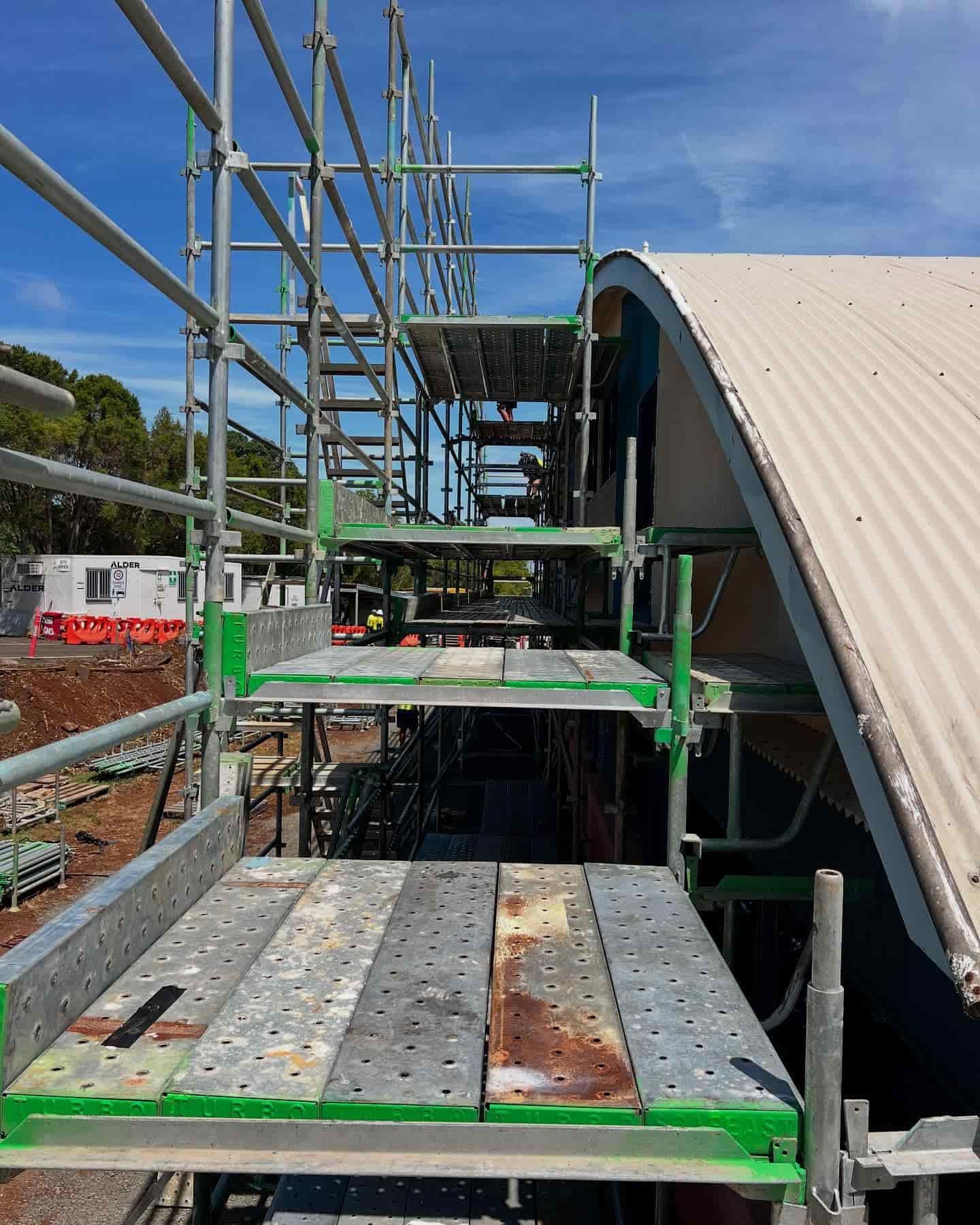 A Row of Scaffolding is Sitting on Top of a Building Under Construction — RM Scaffolding Solutions in Banora Point, NSW