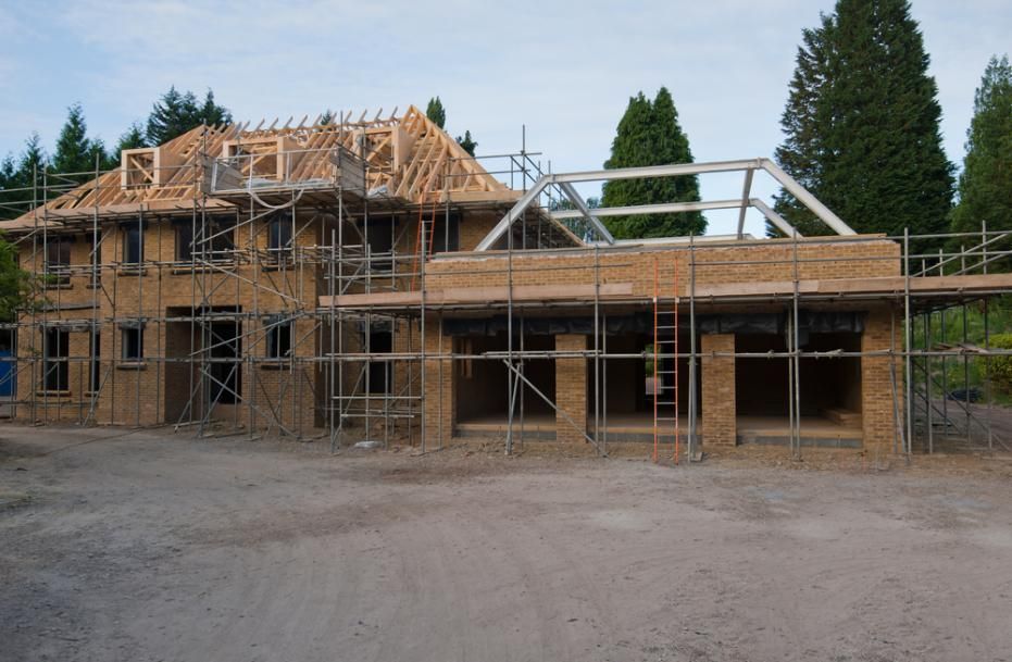 A House is Being Built With Scaffolding Around It — RM Scaffolding Solutions in Pottsville, NSW