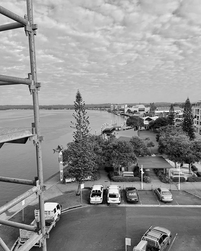 A Black and White Photo of a Parking Lot Next to a Body of Water — RM Scaffolding Solutions in Kingscliff, NSW