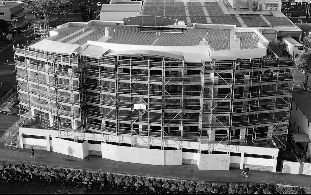 An Aerial View of a Building Under Construction With Scaffolding Around It — RM Scaffolding Solutions in Lennox Head, NSW