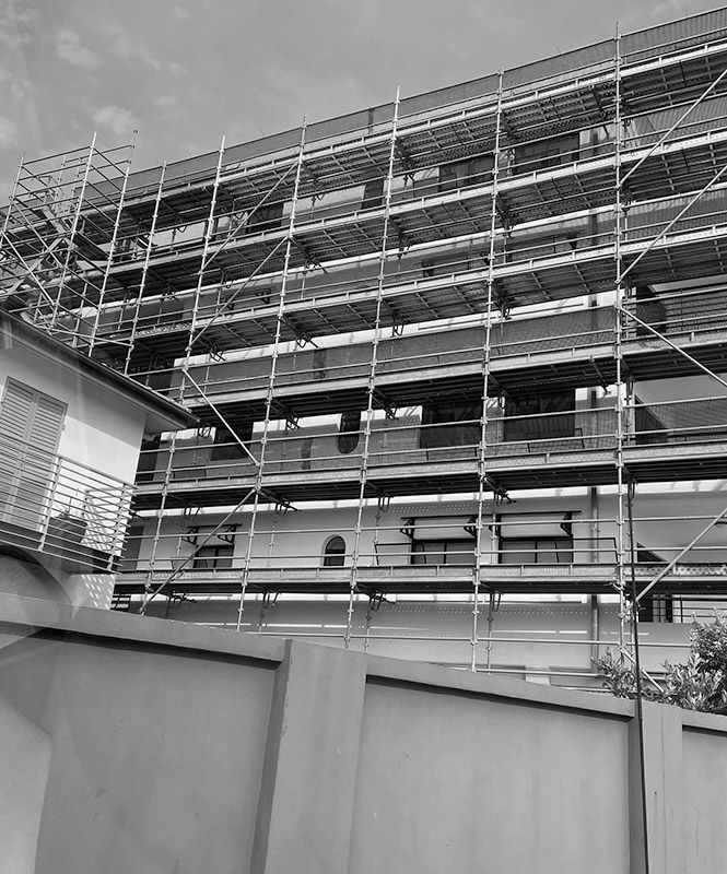 A Black and White Photo of a Building Under Construction With Scaffolding — RM Scaffolding Solutions in Byron Bay, NSW
