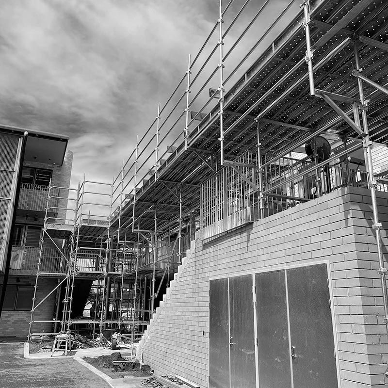A Black and White Photo of a Building Under Construction — RM Scaffolding Solutions in Tweed Coast, NSW
