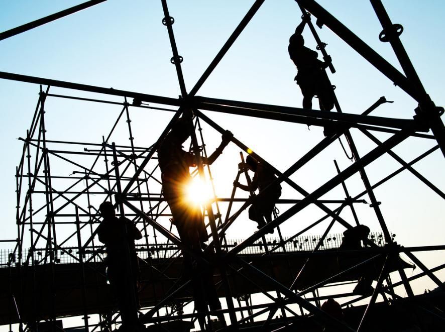 A Group of Construction Workers Are Working on a Scaffolding Structure — RM Scaffolding Solutions in Pottsville, NSW