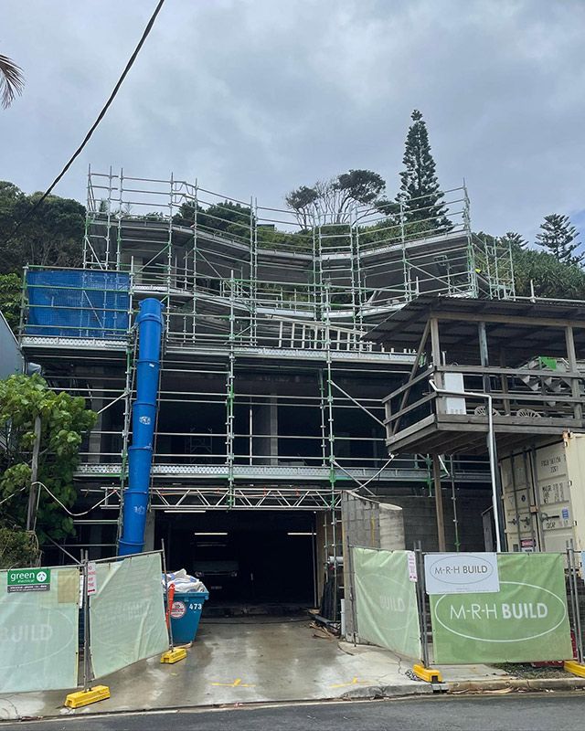 A Large Building Under Construction With Scaffolding on the Side of It — RM Scaffolding Solutions in Murwillumbah, NSW