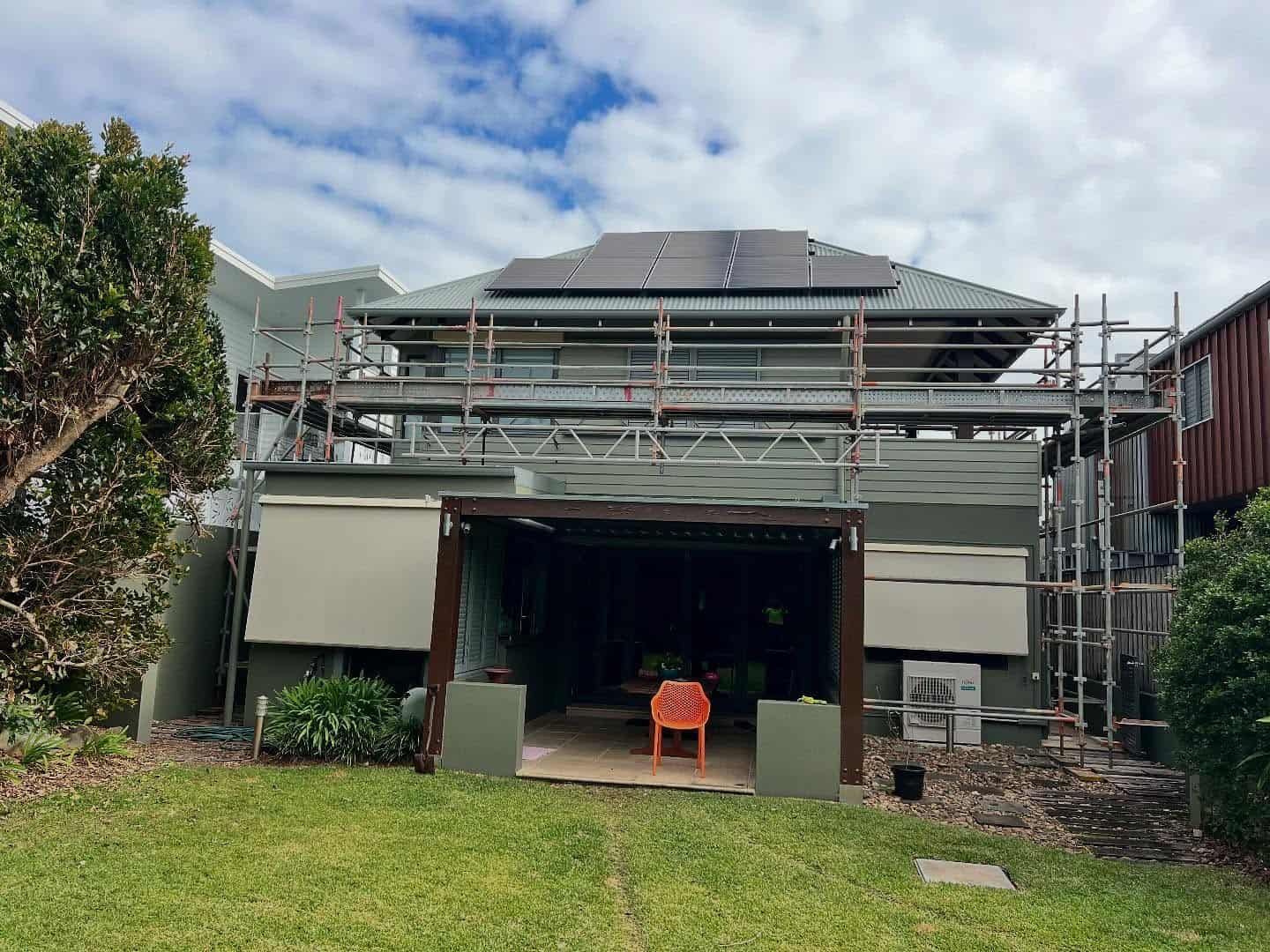 The Back of a House With Scaffolding and Solar Panels on the Roof — RM Scaffolding Solutions in Lennox Head, NSW