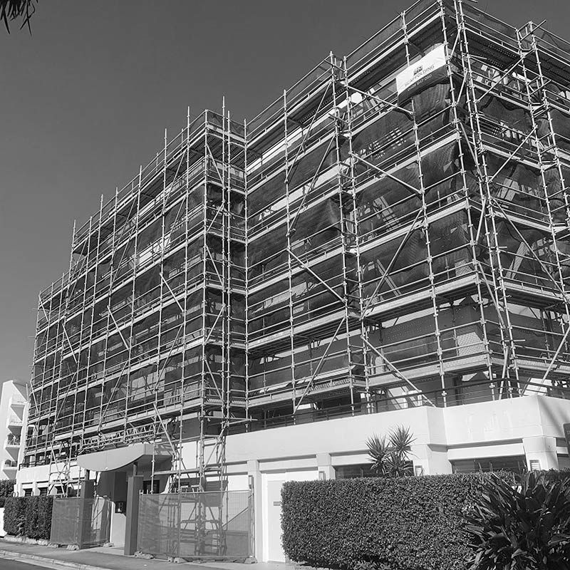 A Large Building is Being Built With Scaffolding Around It — RM Scaffolding Solutions in Northern Rivers, NSW