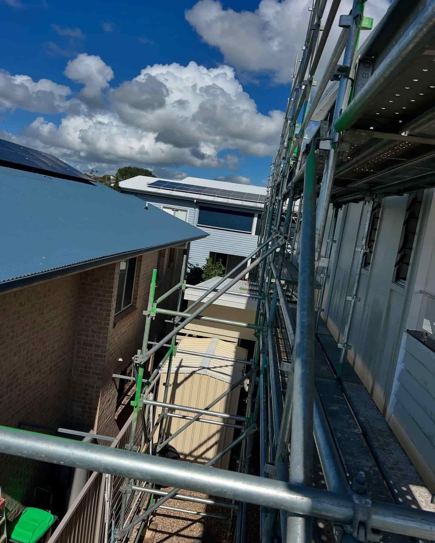 A Row of Scaffolding is Going Up the Side of a Building — RM Scaffolding Solutions in Evans Head, NSW
