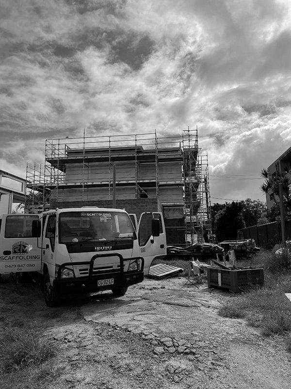 A Truck Parked in Front of a Building Under Construction — RM Scaffolding Solutions in Ballina, NSW