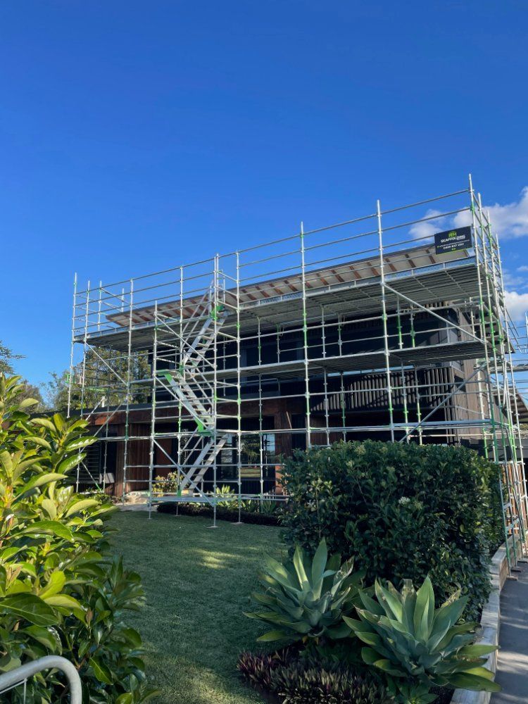 A Large Building is Being Built With Scaffolding Around It — RM Scaffolding Solutions in Yamba, NSW