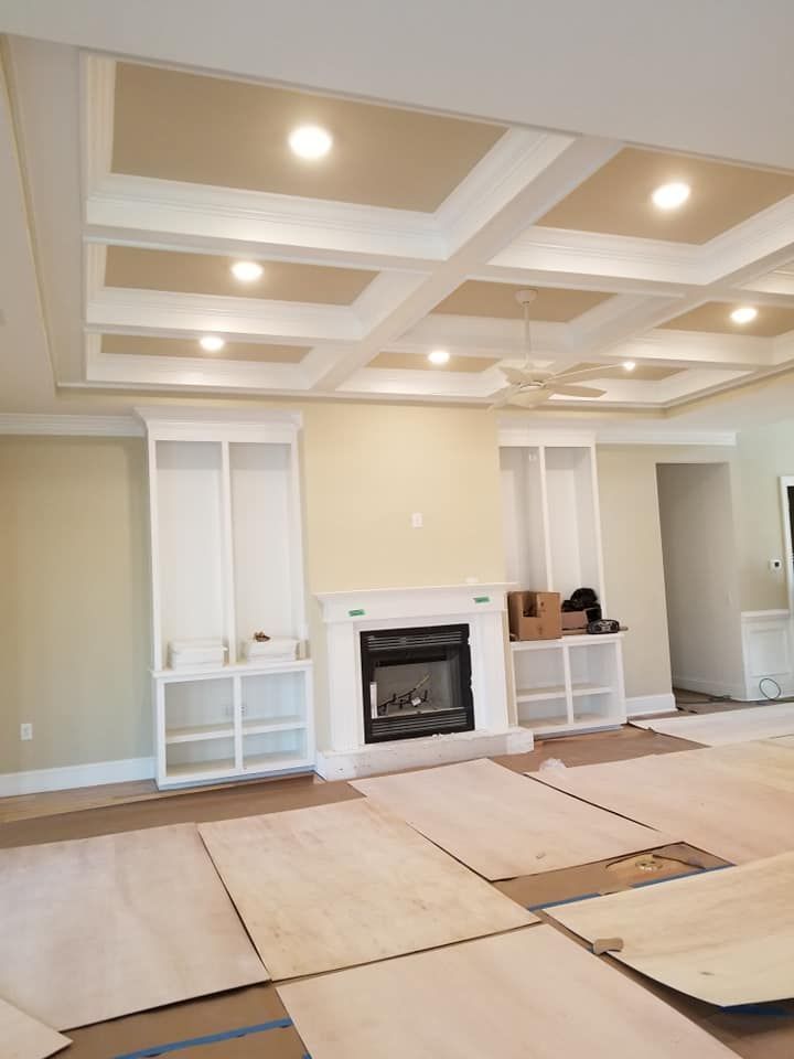 Fireplace, Shelves, and A Coffered Ceiling