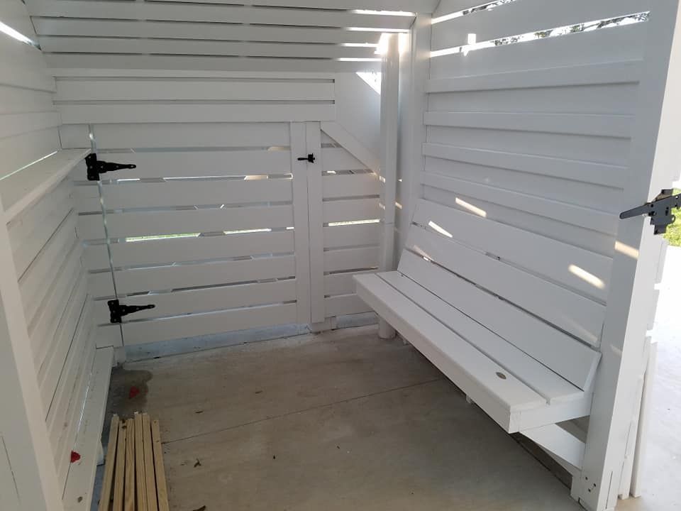 White Shed with A Bench and A Door