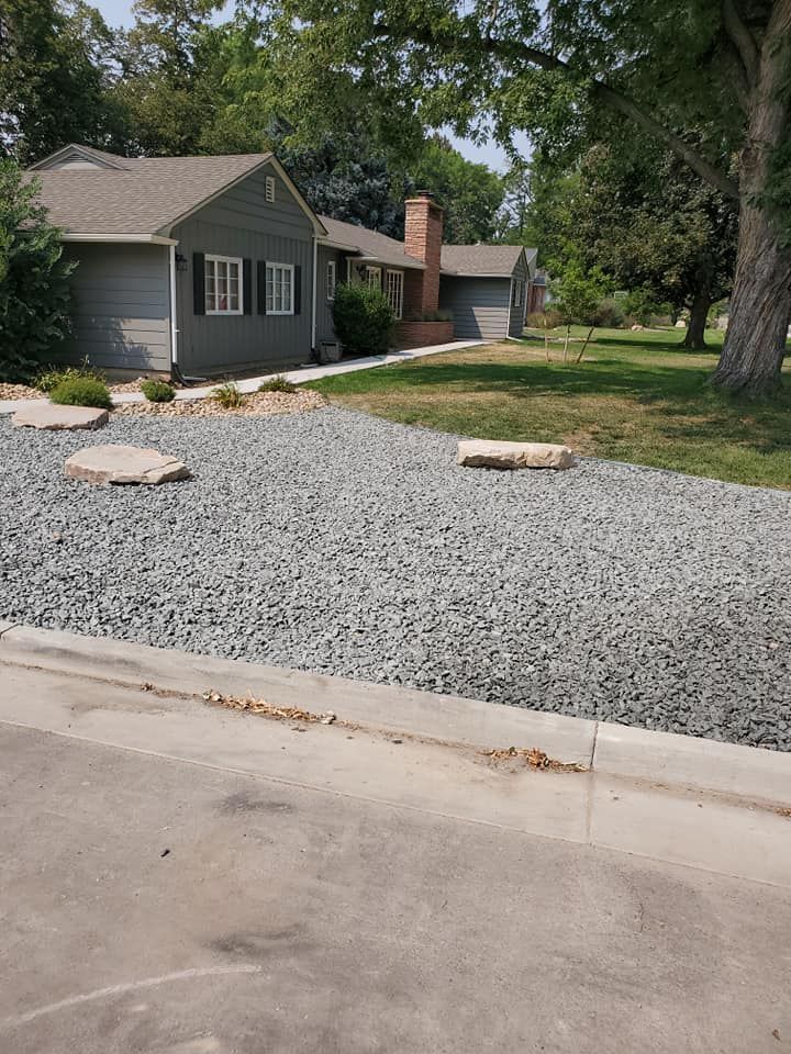 House with gray siding and gravel landscaping.