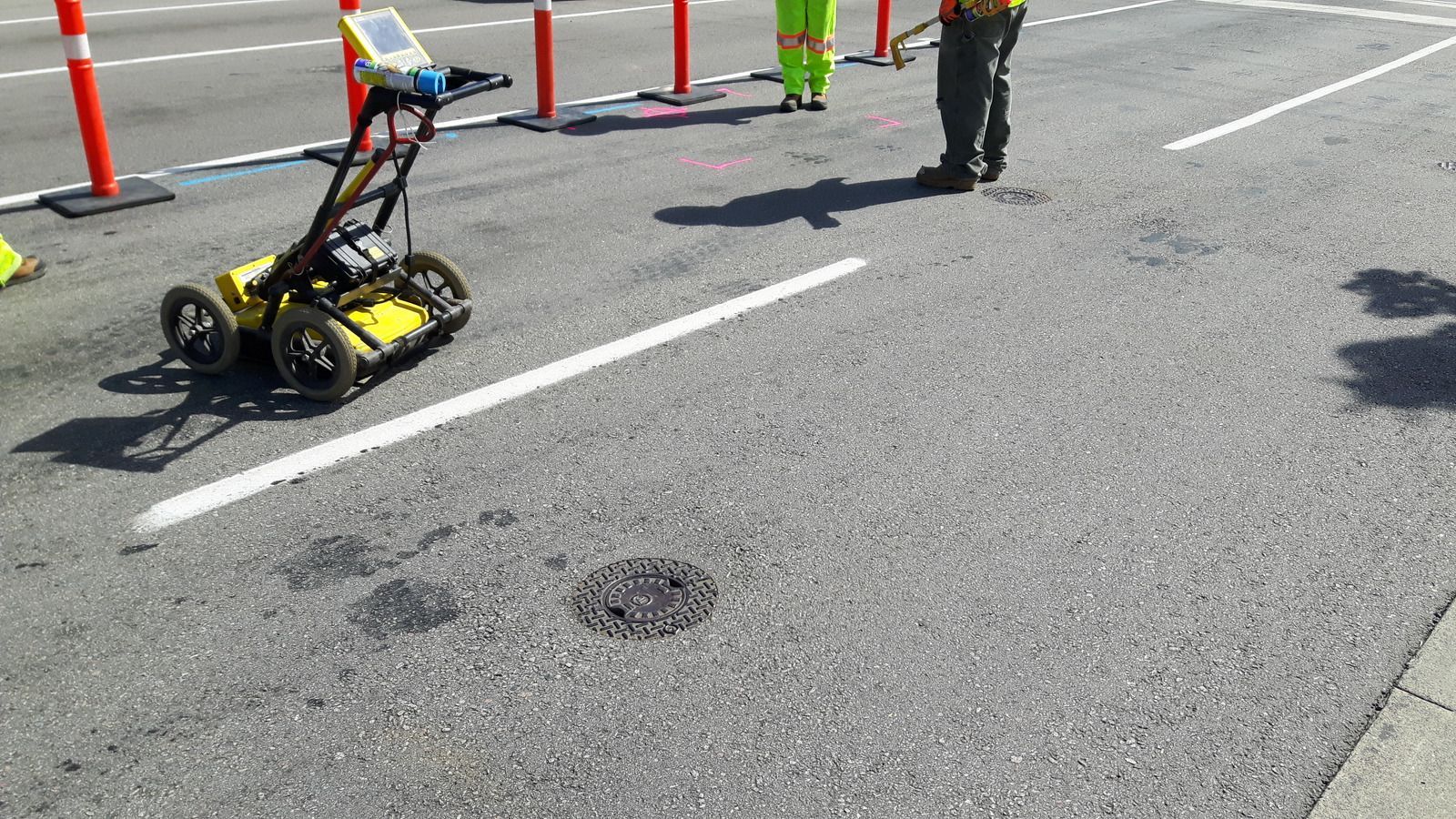 A house with a small excavated area in the yard, ready for planting, with a mountain backdrop.