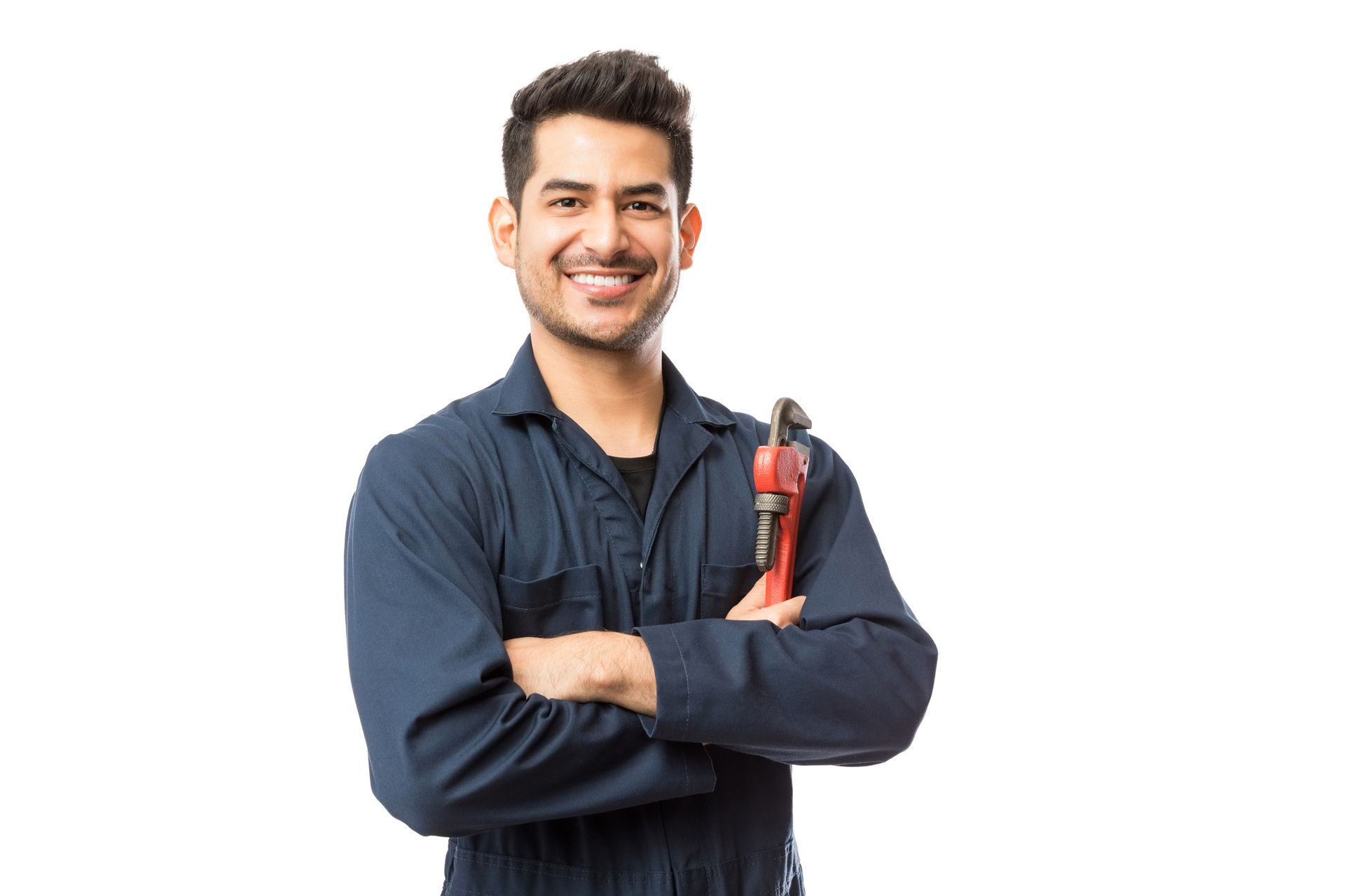 A plumber is standing in front of a water heater holding a wrench.