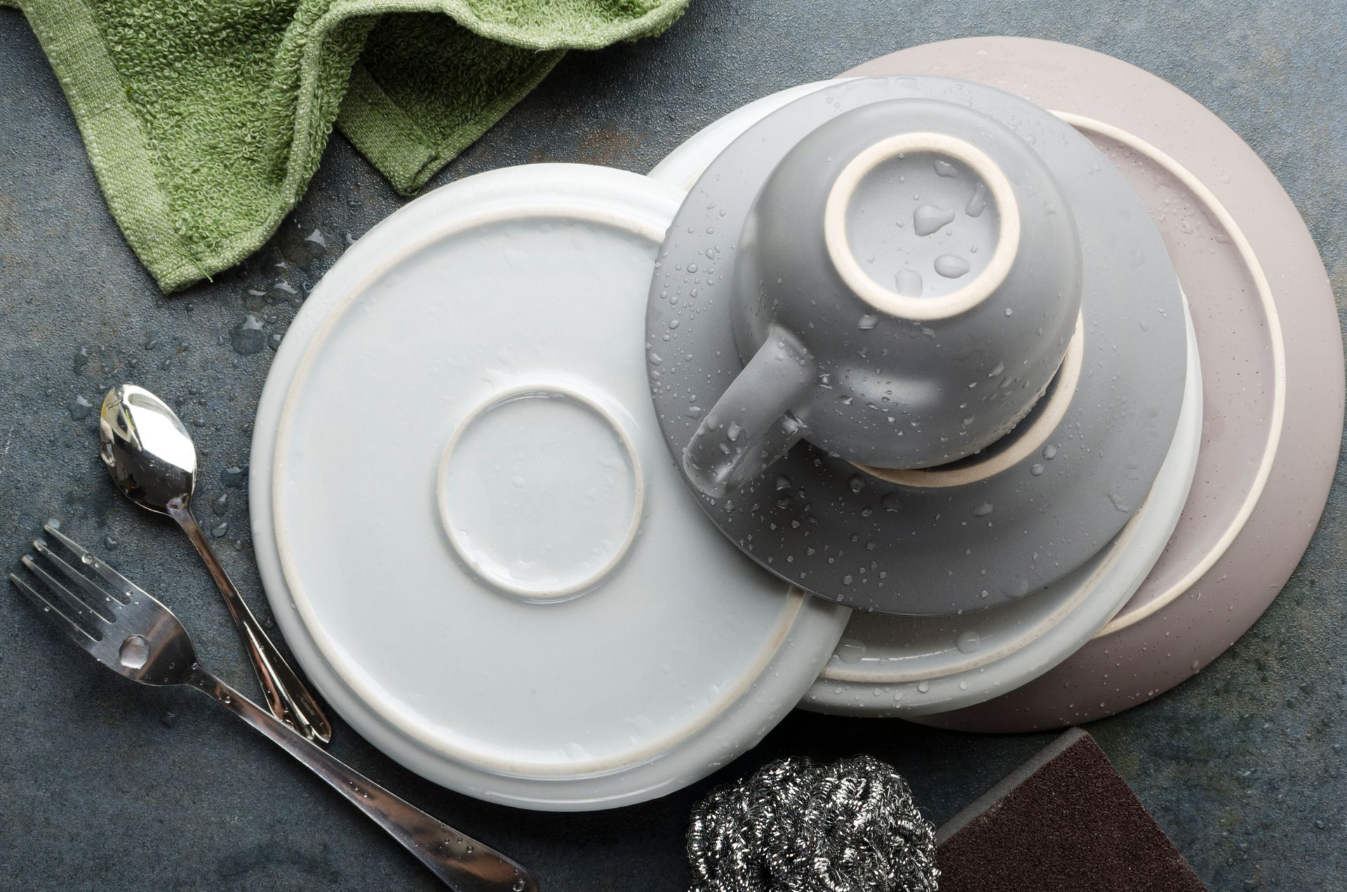 Close-up of hard-water mineral spots on a glass and faucet with limescale.