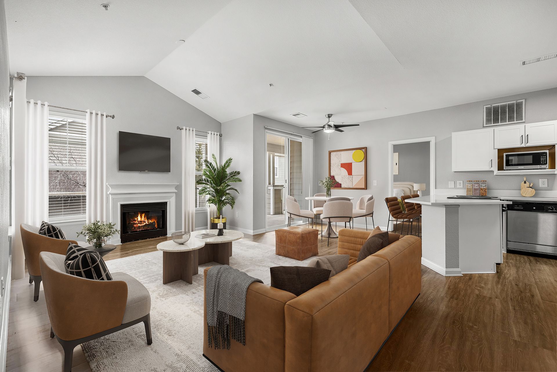 Spacious living room in a modern apartment with fireplace, TV, and seating.