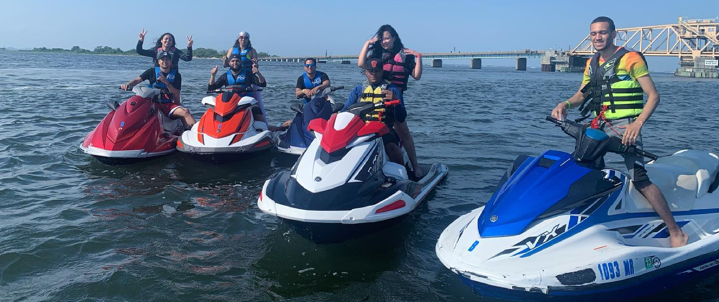 people riding colorful group of jet skis