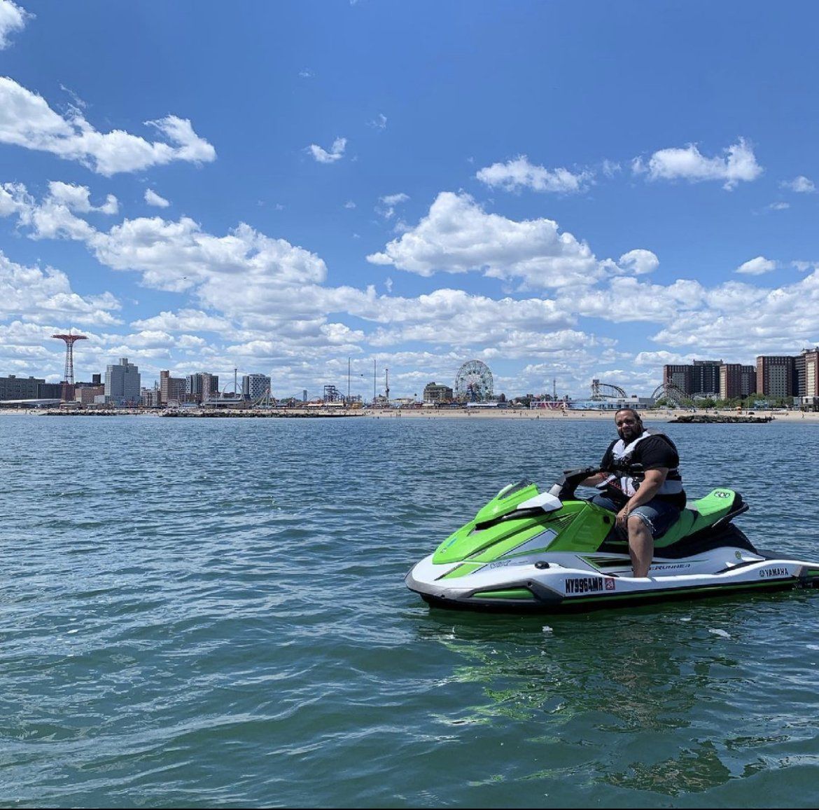 person sitting on green jet ski