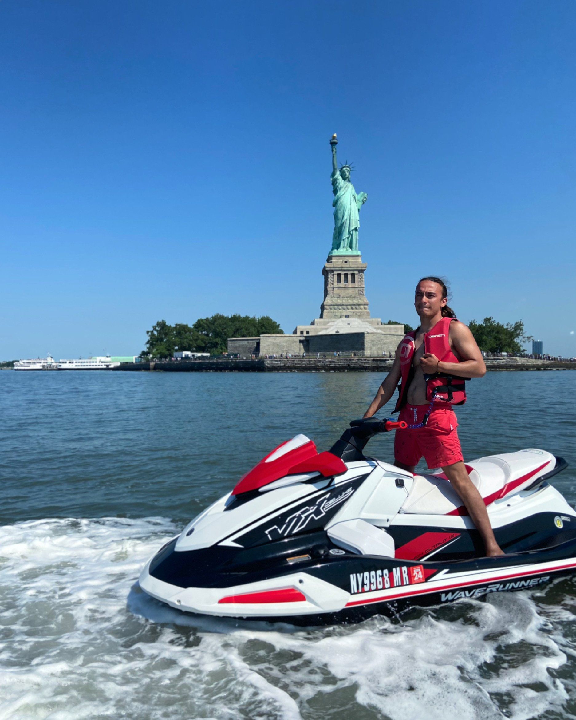 man enjoying riding red jet ski in New York