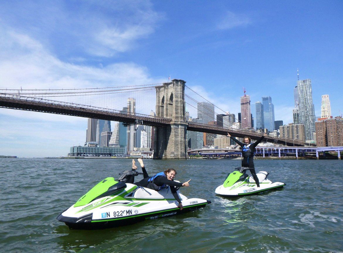 two green jet skis in water