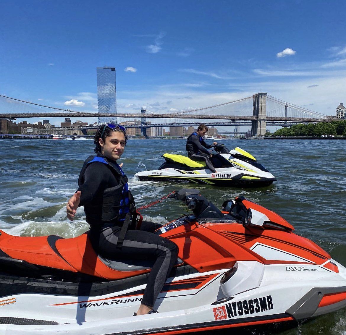 woman sitting on red jet ski