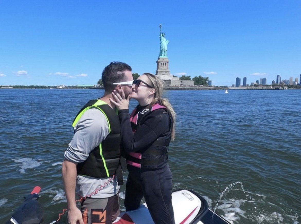 couple kissing on jet ski