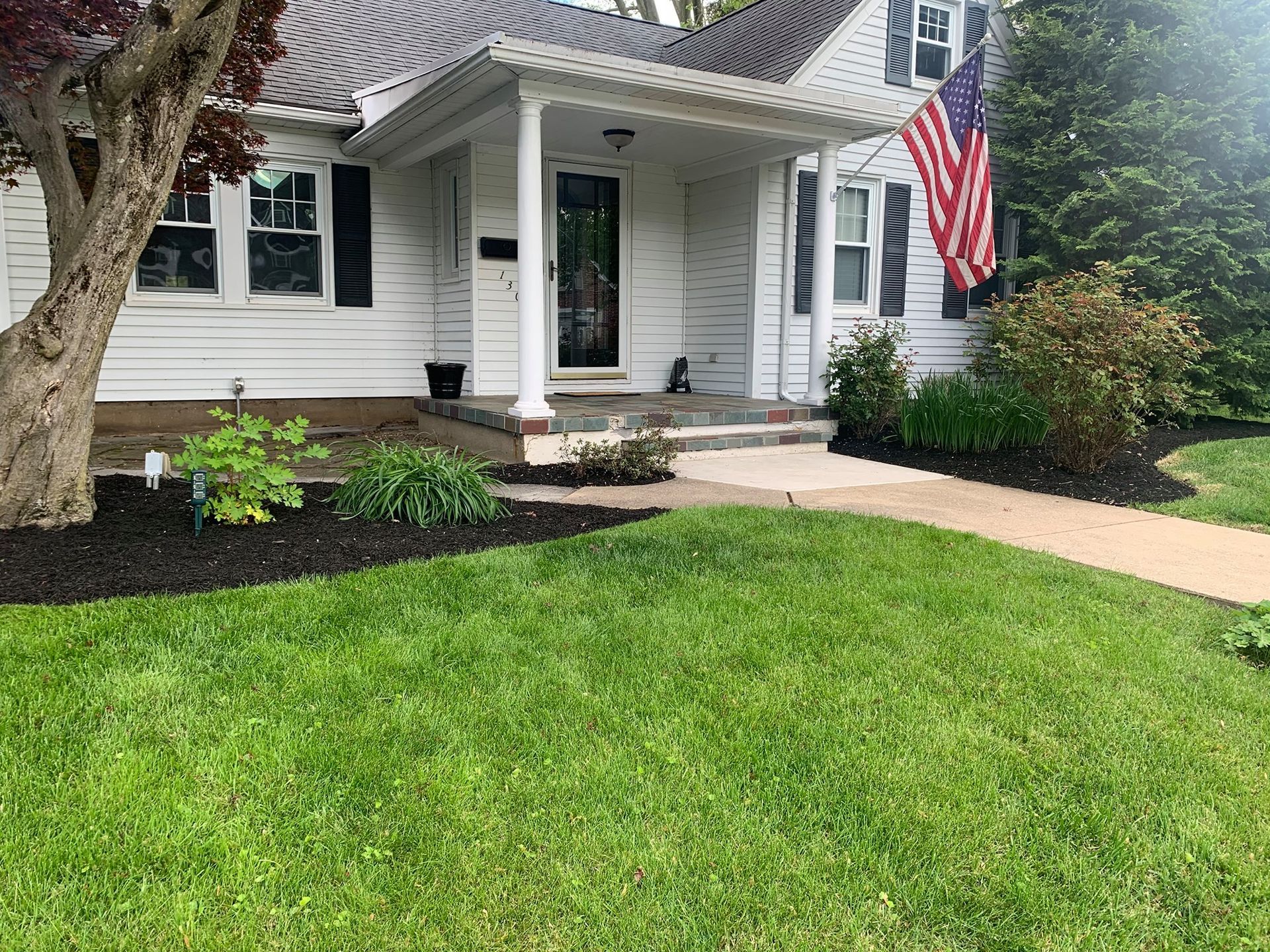 Front Yard With Mulch and Clean Lawn