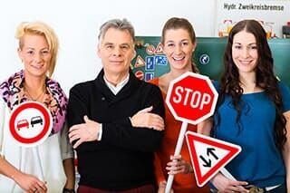 Driving Class Holding Signs — Driving Class in Dr. Williamsburg, VA
