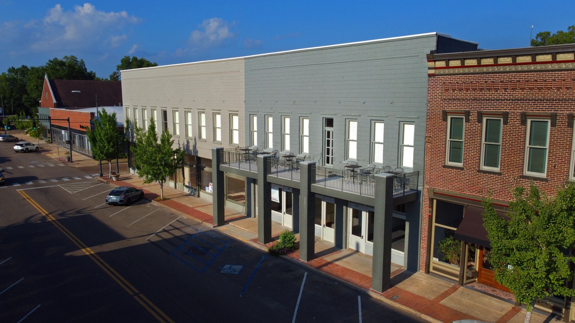 An aerial view of a row of buildings on a city street.