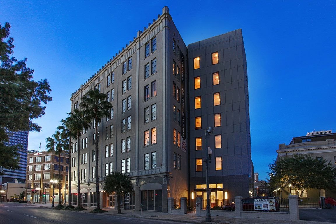 A large building with a lot of windows is lit up at night.