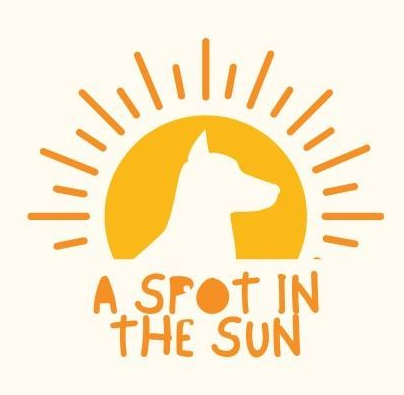 A yellow logo showing a dog silhouette inside a sun, with the text