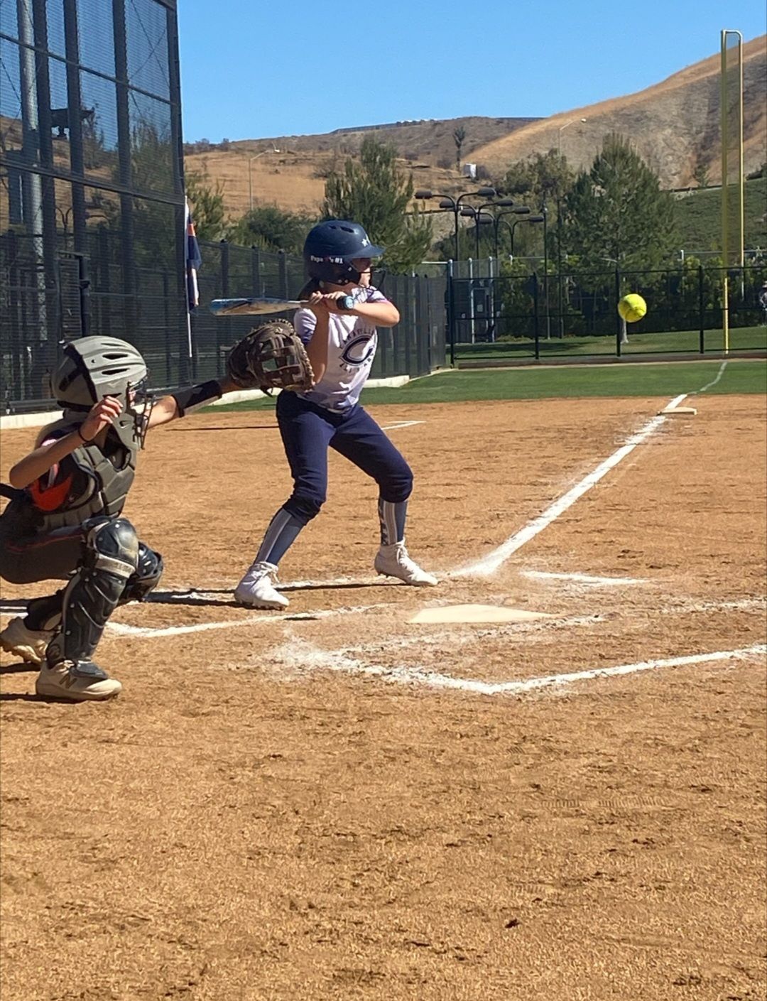 Baseball on a dark surface, with visible stitching.