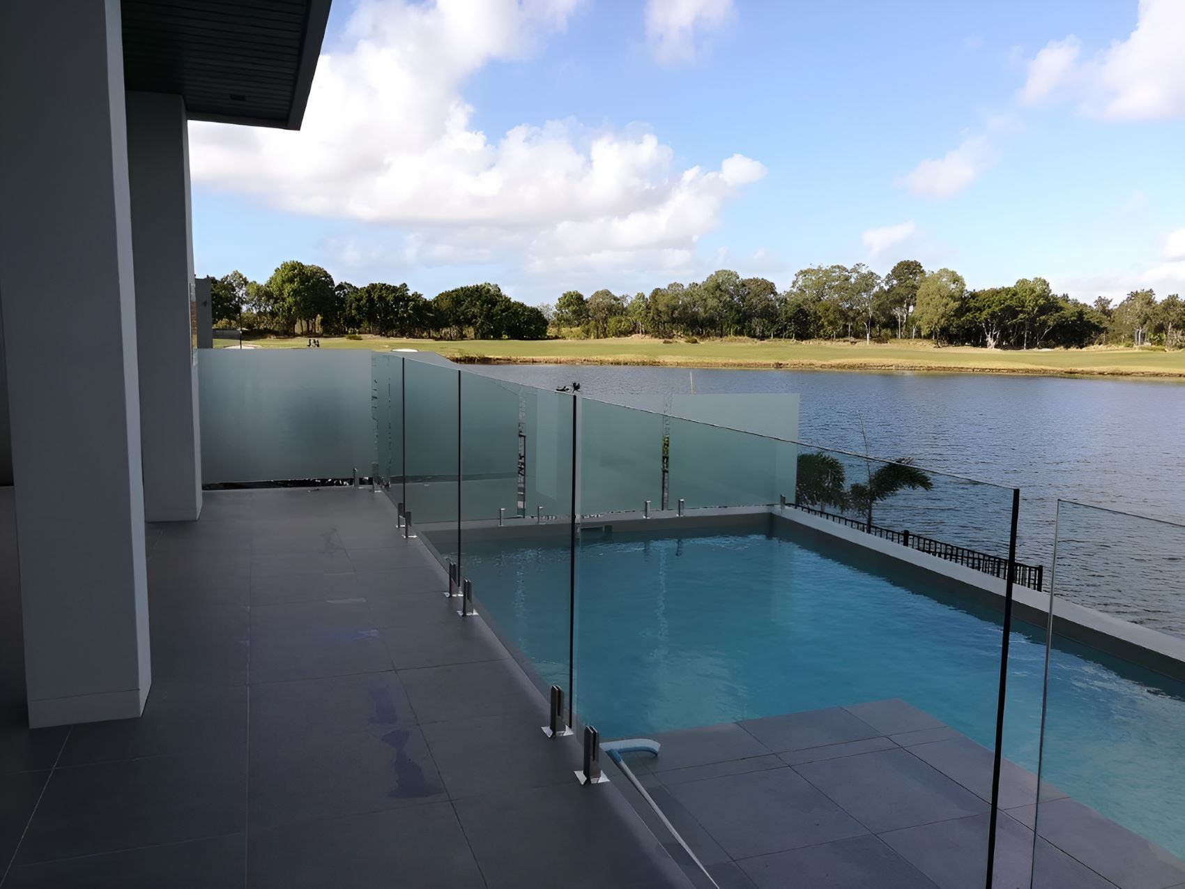 A Swimming Pool Surrounded by Nature — Top Shelf Glass Pool Fencing & Balustrading in Merrimac, QLD
