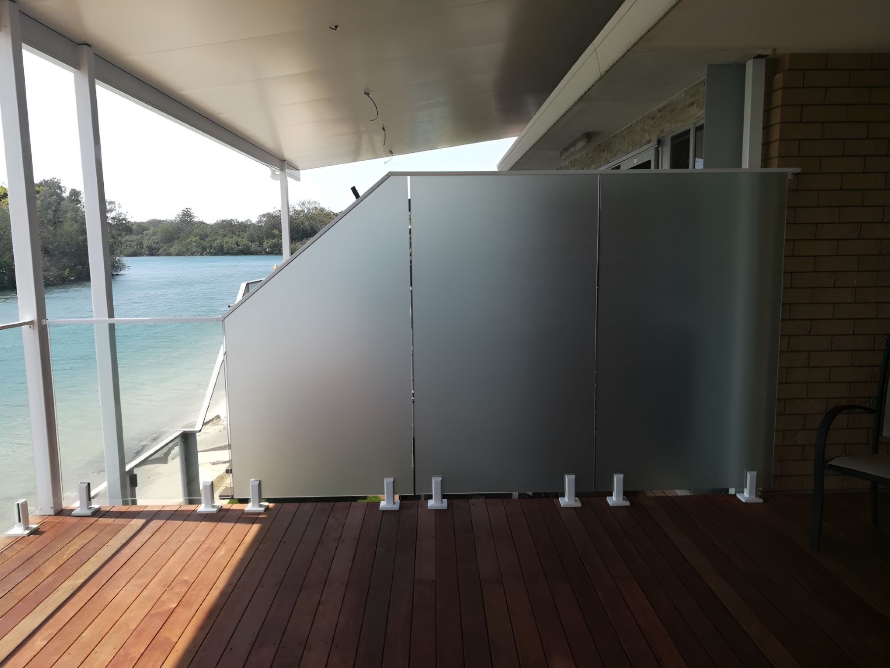 A Balcony With a View of a Body of Water — Top Shelf Glass Pool Fencing & Balustrading in Merrimac, QLD