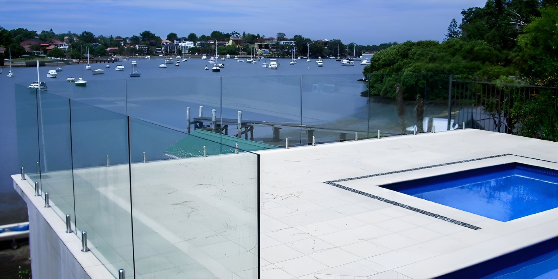 A Swimming Pool With a View of a Body of Water — Top Shelf Glass Pool Fencing & Balustrading in Tweed Heads, QLD