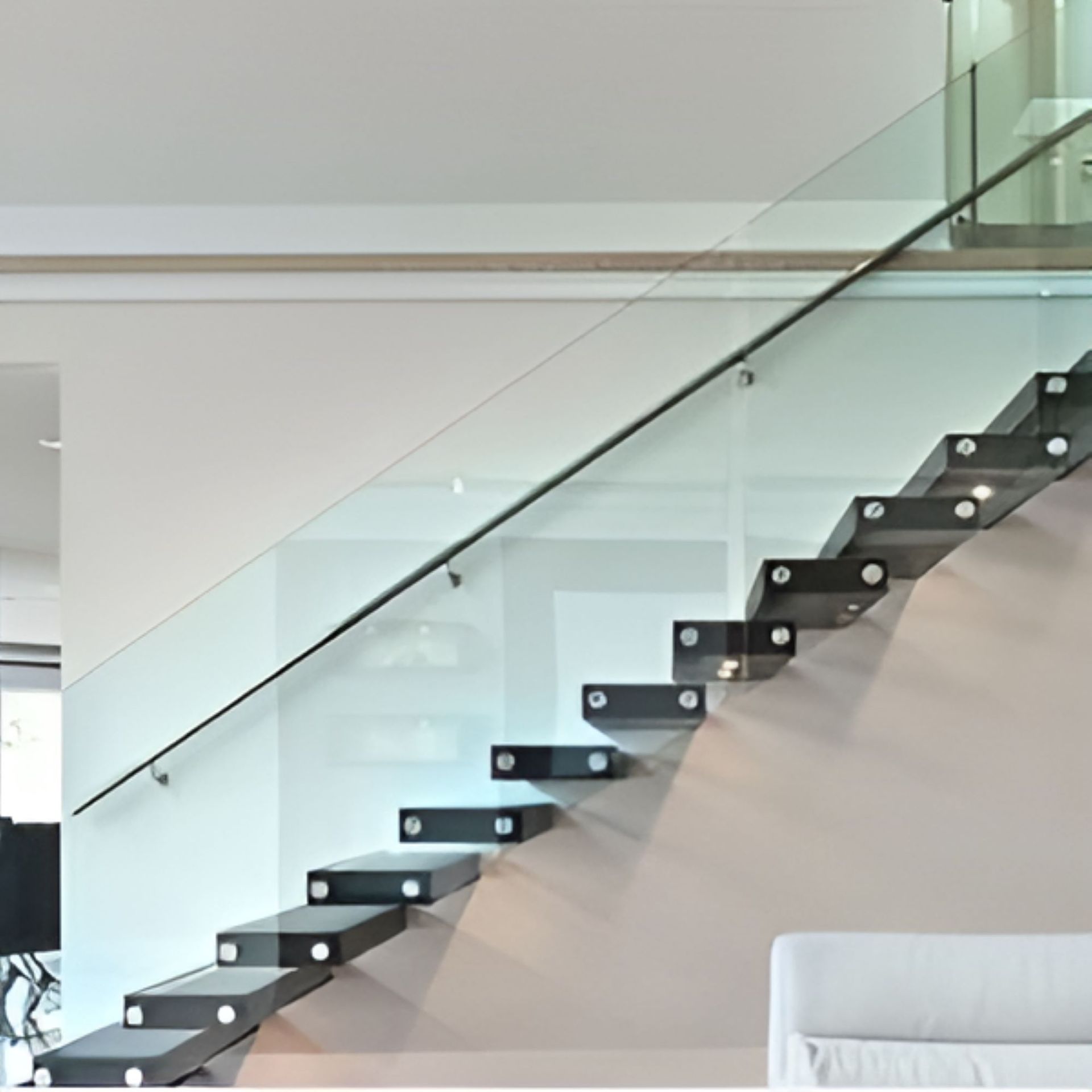 A Staircase With a Glass Railing in a Living Room — Top Shelf Glass Pool Fencing & Balustrading in Merrimac, QLD