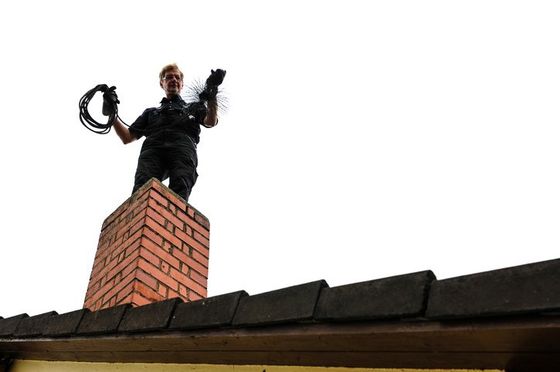 Chimney Cleaning — Man Cleaning the Chimney in Oreland, PA